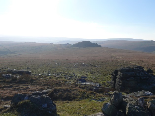 Looking back into the sun to Longaford Tor and Littaford Tor
