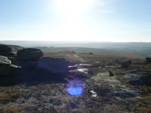 Looking back into the sun from Littaford Tor with Little Bee Tor nearest.