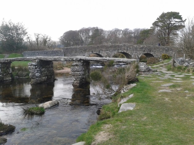 The clapper bridge and road bridge behind at Postbridge