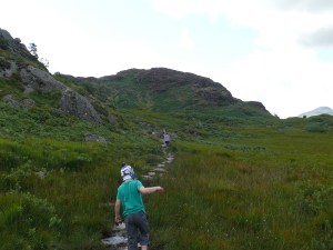 Heading across the stepping stones with Great Crag ahead
