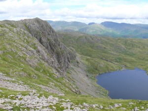 Heading round to Harrison Stickle with the vertical face of Pavey Ark over Stickle Tarn.