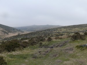 Climbing the side of Crocken Tor and looking at a rather gloomy Longaford Tor