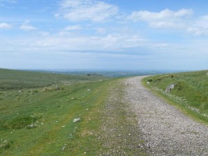 Looking back along the old railway path with Ingra Tor in the middle distance and Cornwall beyond