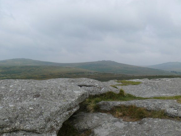 Pew Tor summit looking back to a murky Cox Tor left and the Staple Tors right