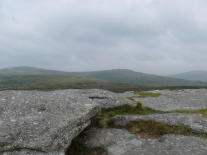 Pew Tor summit looking back to a murky Cox Tor left and the Staple Tors right